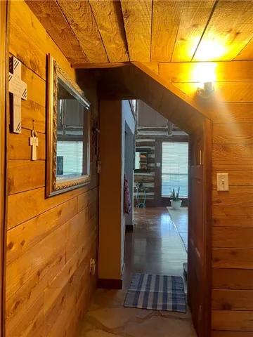 a bedroom with a bed next to a large window with a flat screen tv