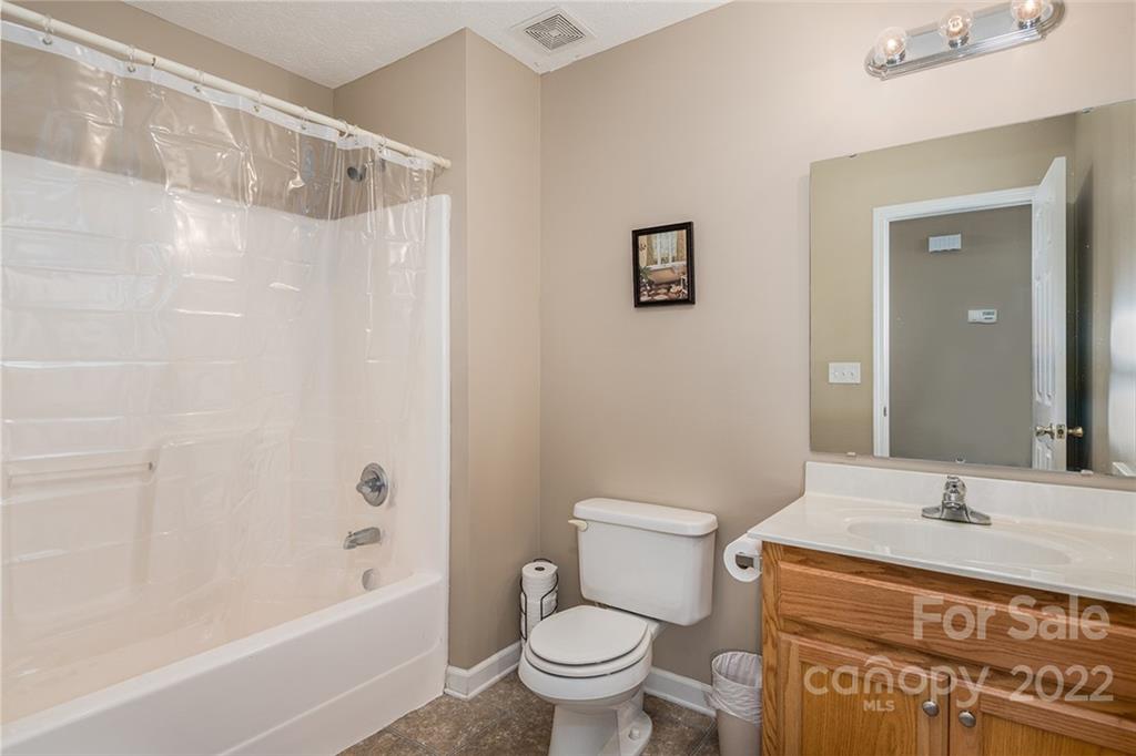 4226 Hickory Nut Ridge Road Hudson, NC 28638 - Photo 14 of 20 a bathroom with a granite countertop sink a toilet and shower