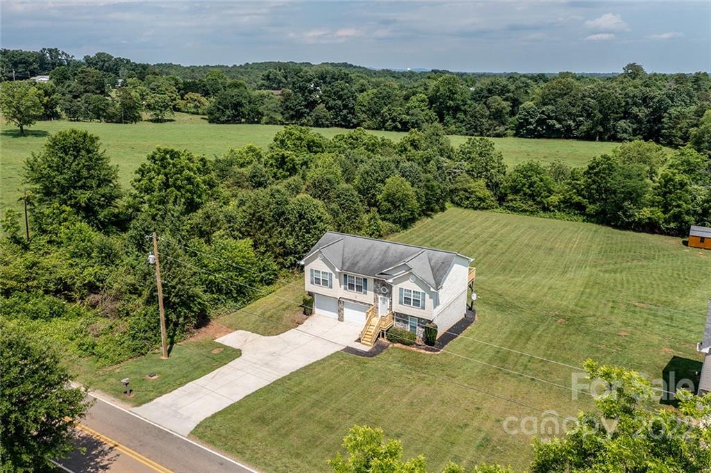 4226 Hickory Nut Ridge Road Hudson, NC 28638 - Photo 3 of 20 an aerial view of a house with a yard and lake view