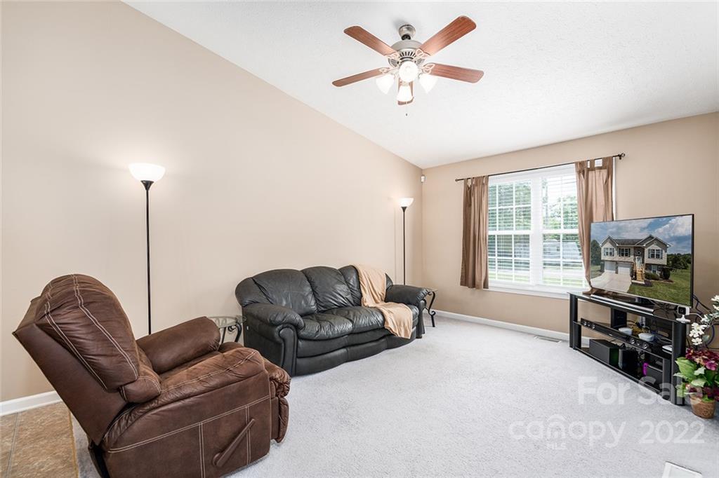 4226 Hickory Nut Ridge Road Hudson, NC 28638 - Photo 8 of 20 a living room with furniture a flat screen tv and a window