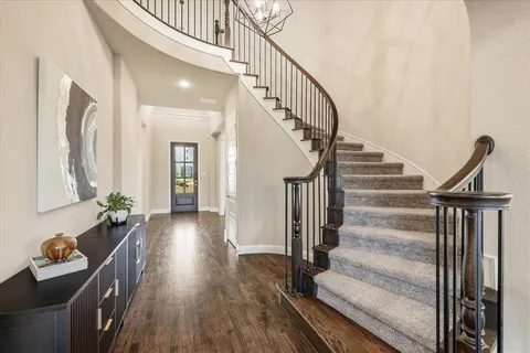 a view of entryway and hall with wooden floor