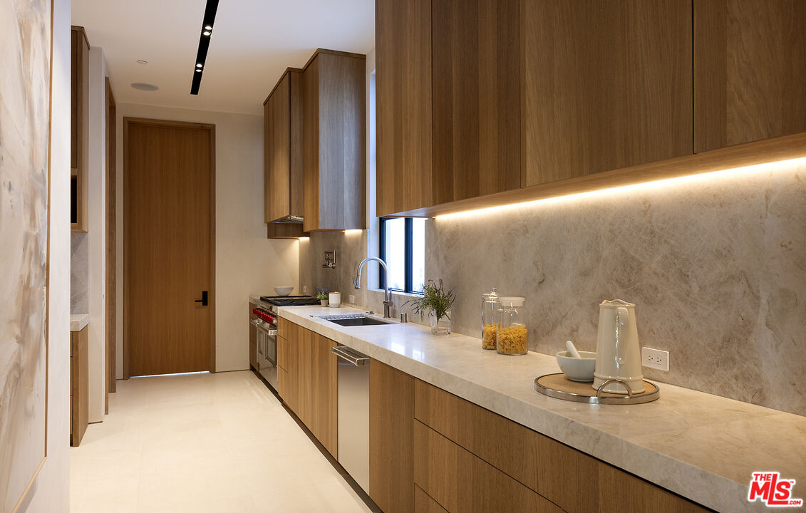 1165 Somera Road Los Angeles, CA 90077 - Photo 11 of 44 a bathroom with a double vanity sink and a mirror