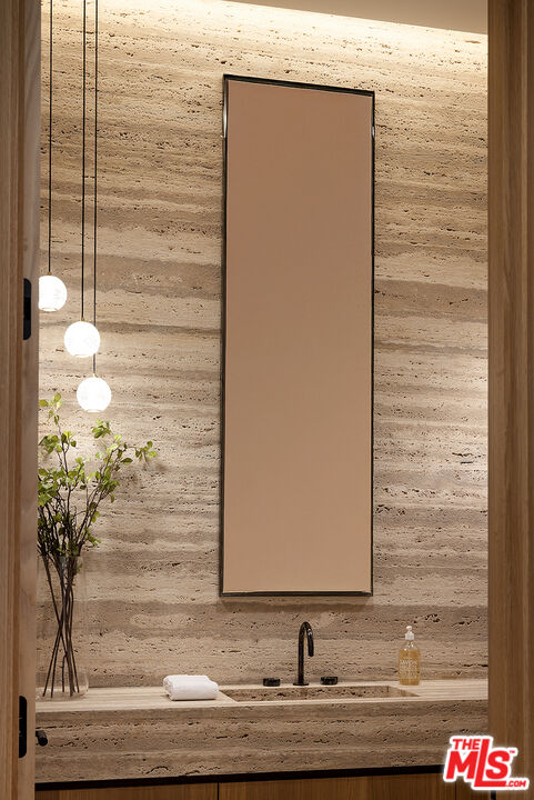 1165 Somera Road Los Angeles, CA 90077 - Photo 13 of 44 a bathroom with a granite countertop sink and a mirror