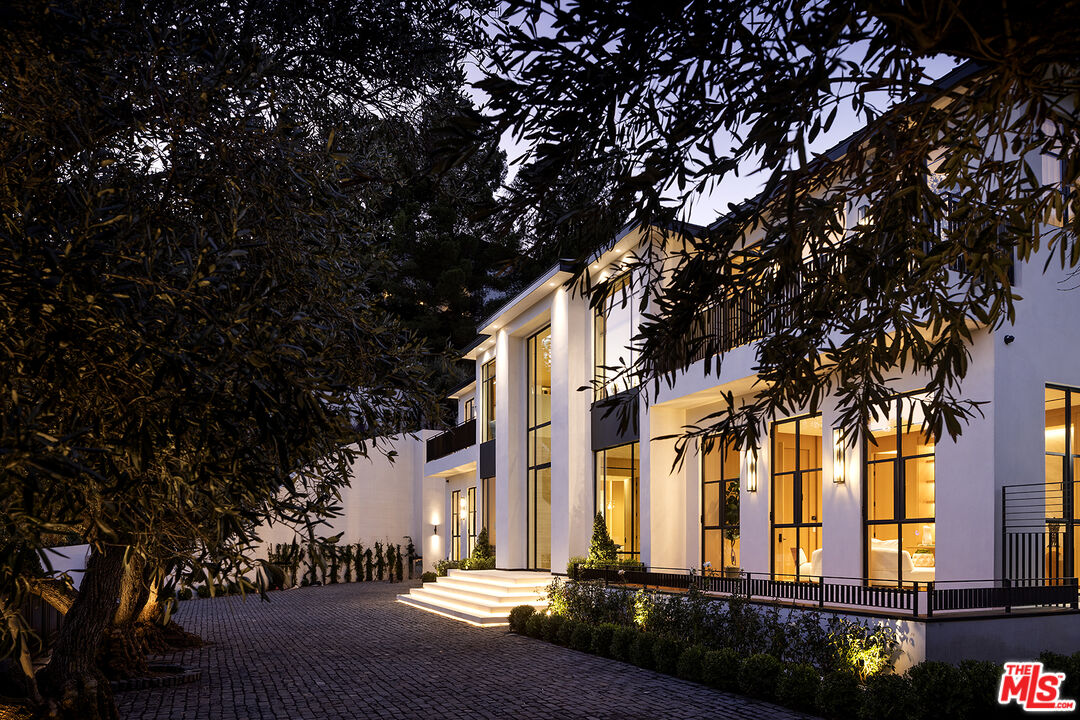 1165 Somera Road Los Angeles, CA 90077 - Photo 2 of 44 a front view of a building with trees and plants