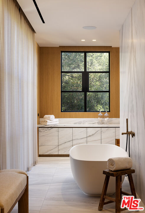 1165 Somera Road Los Angeles, CA 90077 - Photo 23 of 44 a bathroom with a bathtub and window