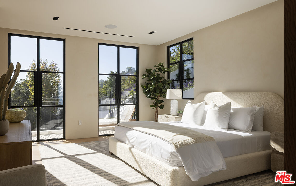 1165 Somera Road Los Angeles, CA 90077 - Photo 27 of 44 a bedroom with a large bed and a large window