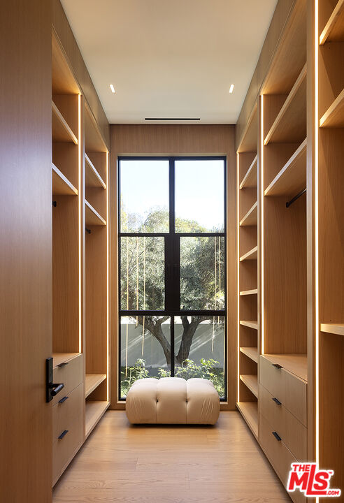 1165 Somera Road Los Angeles, CA 90077 - Photo 31 of 44 a hallway with a large window and couch