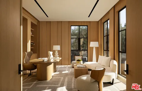 a living room with fireplace furniture and a large window