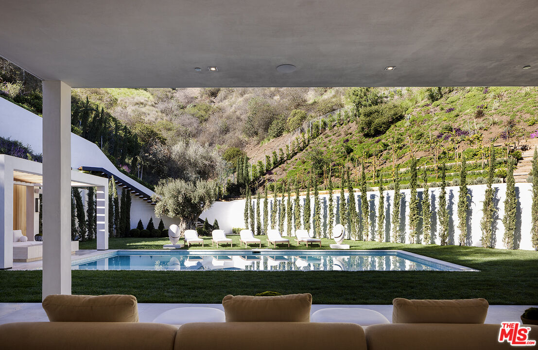 1165 Somera Road Los Angeles, CA 90077 - Photo 41 of 44 a living room filled with couches and a potted plant