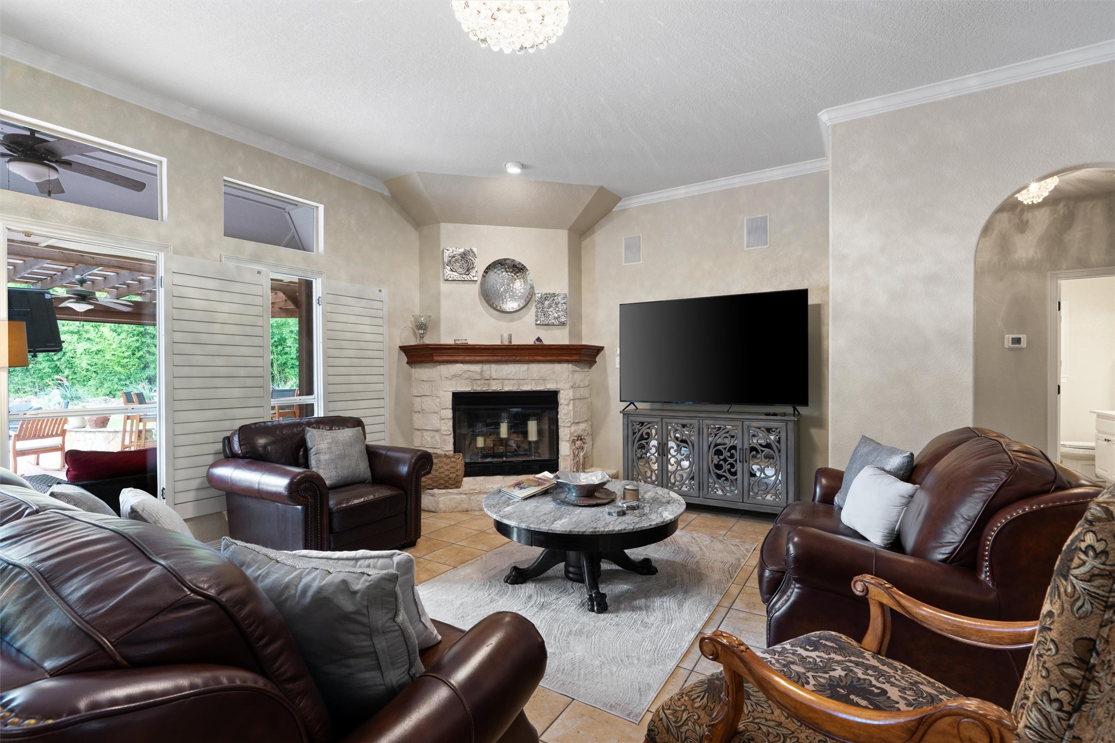 223 East Ridgewood Road Georgetown, TX 78633 - Photo 8 of 40 A fireplace with a stone hearth in the living room offering direct views of the outdoor pool