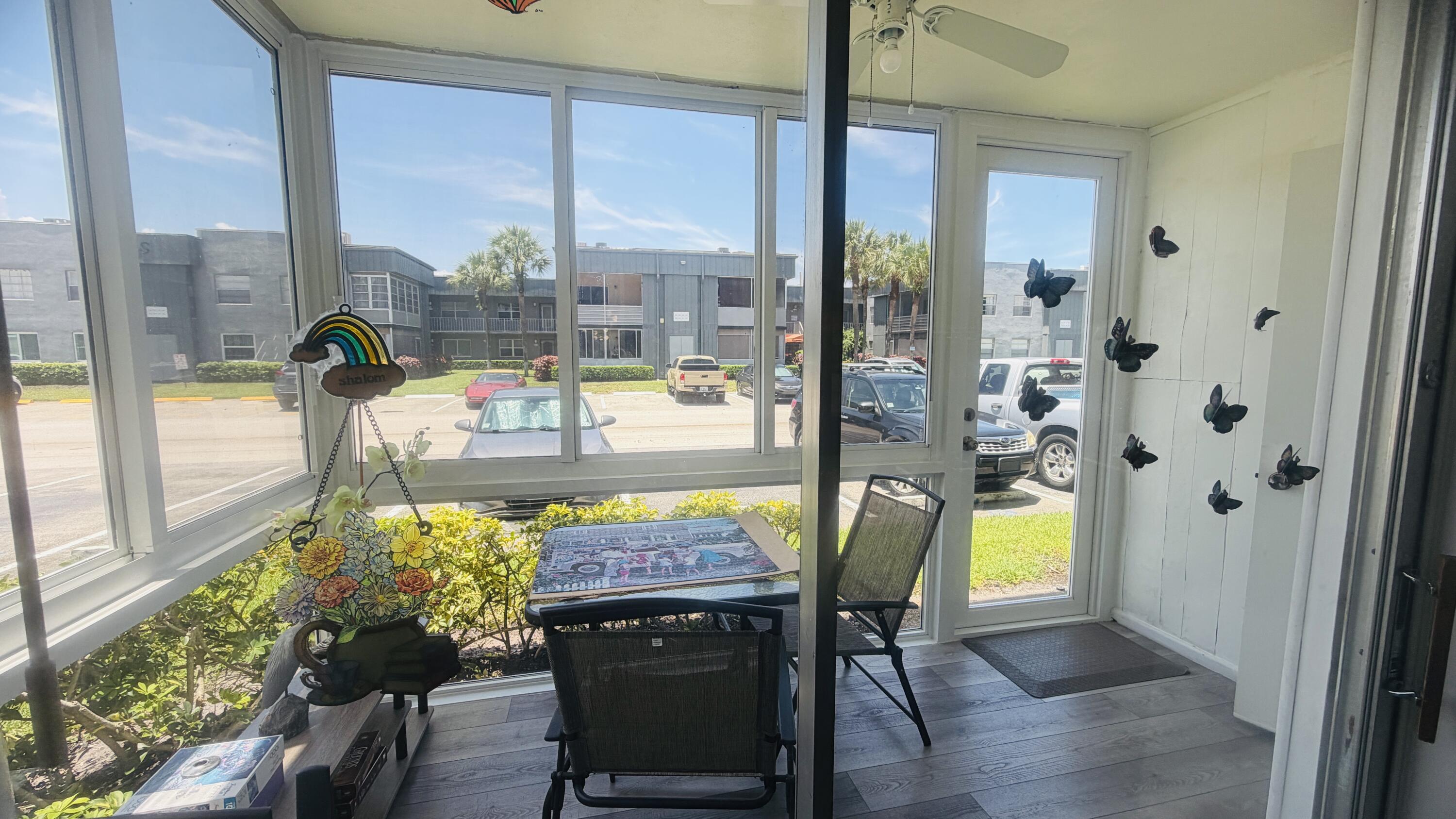 930 Normandy Trail Delray Beach, FL 33484 - Photo 6 of 34 a living room with furniture and a floor to ceiling window