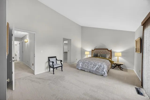 a bedroom with a bed and chair