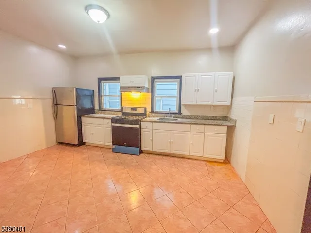 a kitchen with a refrigerator sink and stove