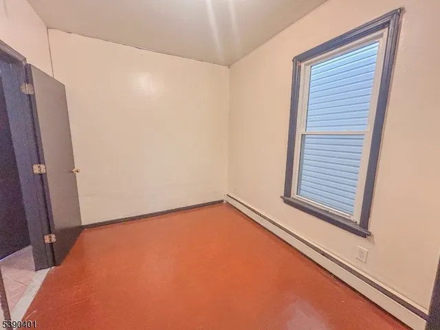 a view of a room with a wooden floor and a window