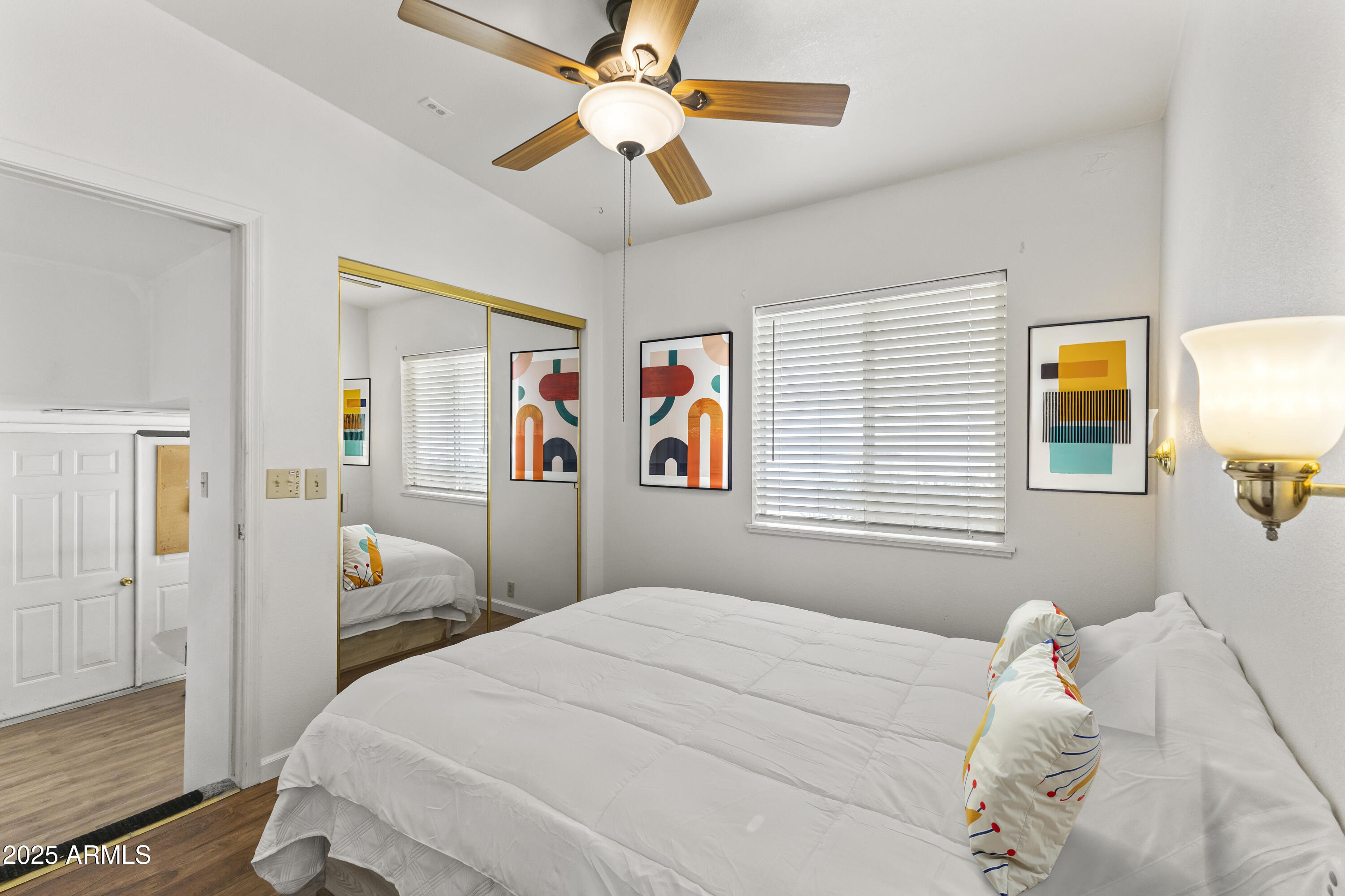 17200 West Bell Road, Unit 771 Surprise, AZ 85374 - Photo 24 of 37 a bedroom with a bed and a chandelier