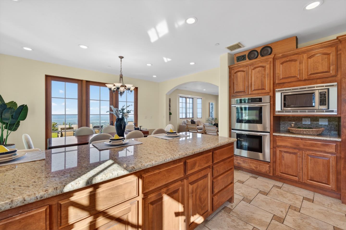 17599 Montebello Road Cupertino, CA 95014 - Photo 21 of 83 a kitchen with stainless steel appliances granite countertop a stove a sink and a microwave