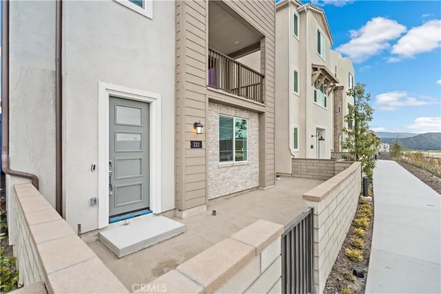 a living room with furniture kitchen view and a large window