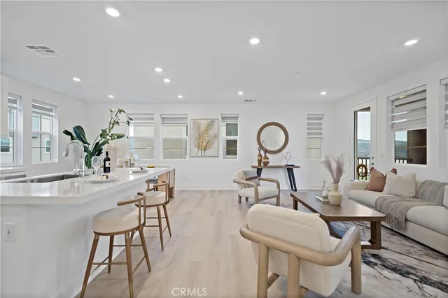 a kitchen with stainless steel appliances kitchen island granite countertop a stove a sink a dining table and chairs