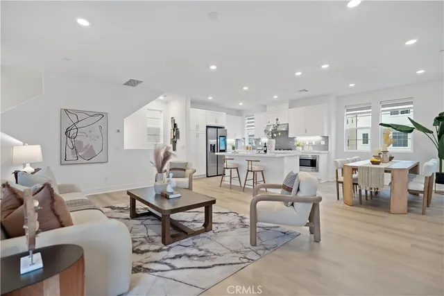 a living room with furniture a rug and a table