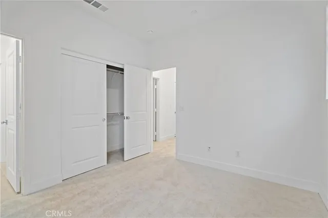 a bedroom with a bed and a potted plant