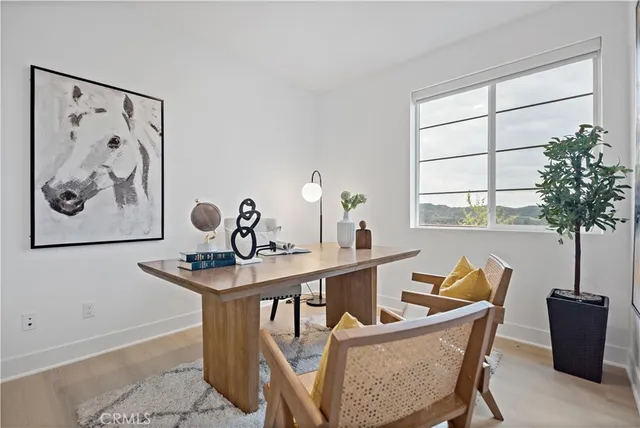 a view of a workspace with furniture and a potted plant