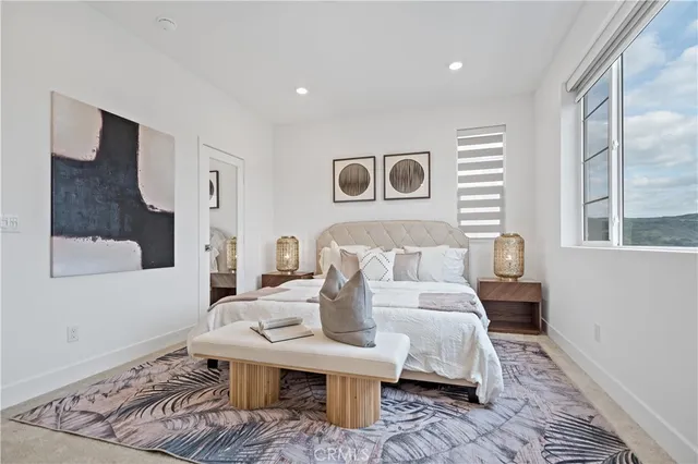 a bedroom with a bed and a window