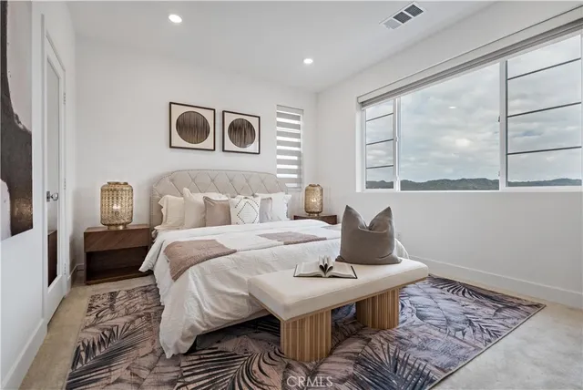 a spacious bathroom with a granite countertop sink and a mirror