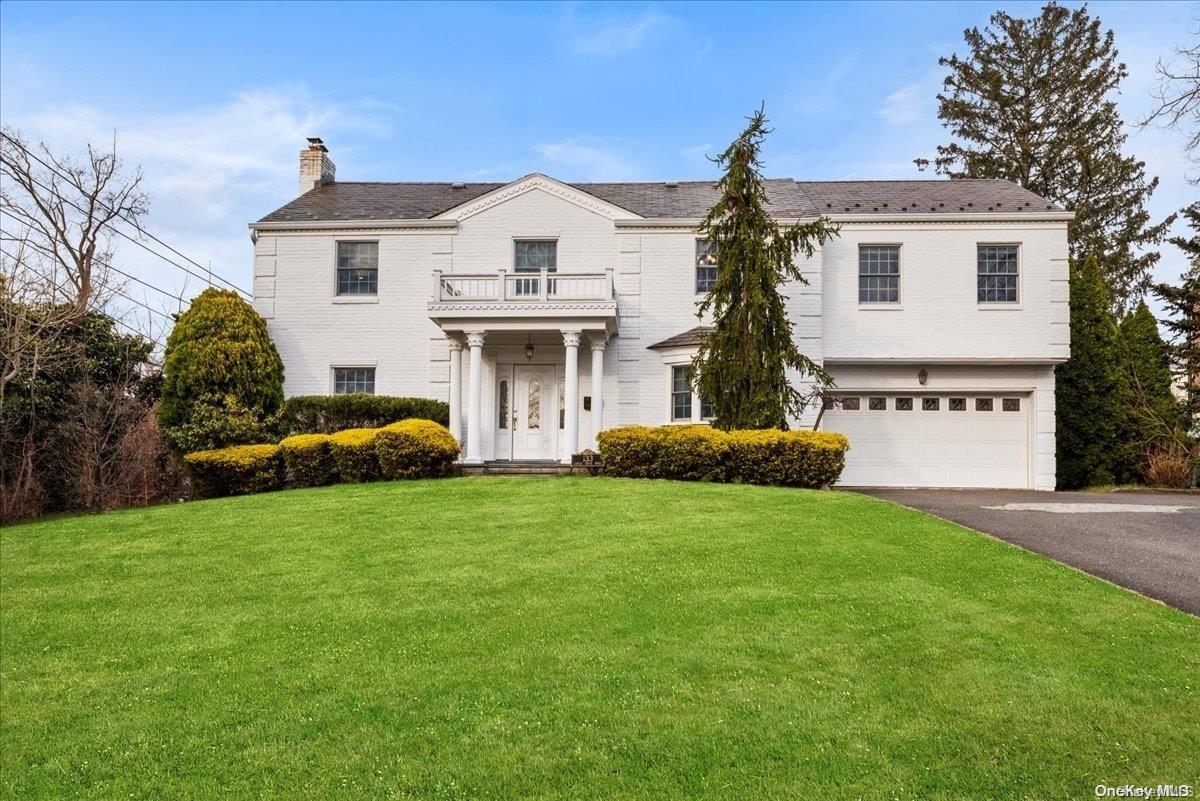 133 Castle Ridge Road Manhasset, NY 11030 - Photo 1 of 1 a front view of a house with a garden