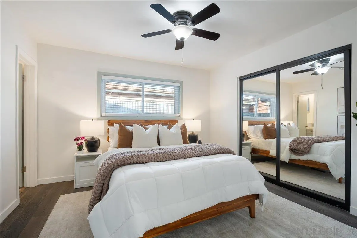 941 8th Street Imperial Beach, CA 91932 - Photo 11 of 22 a bedroom with bed and a large mirror