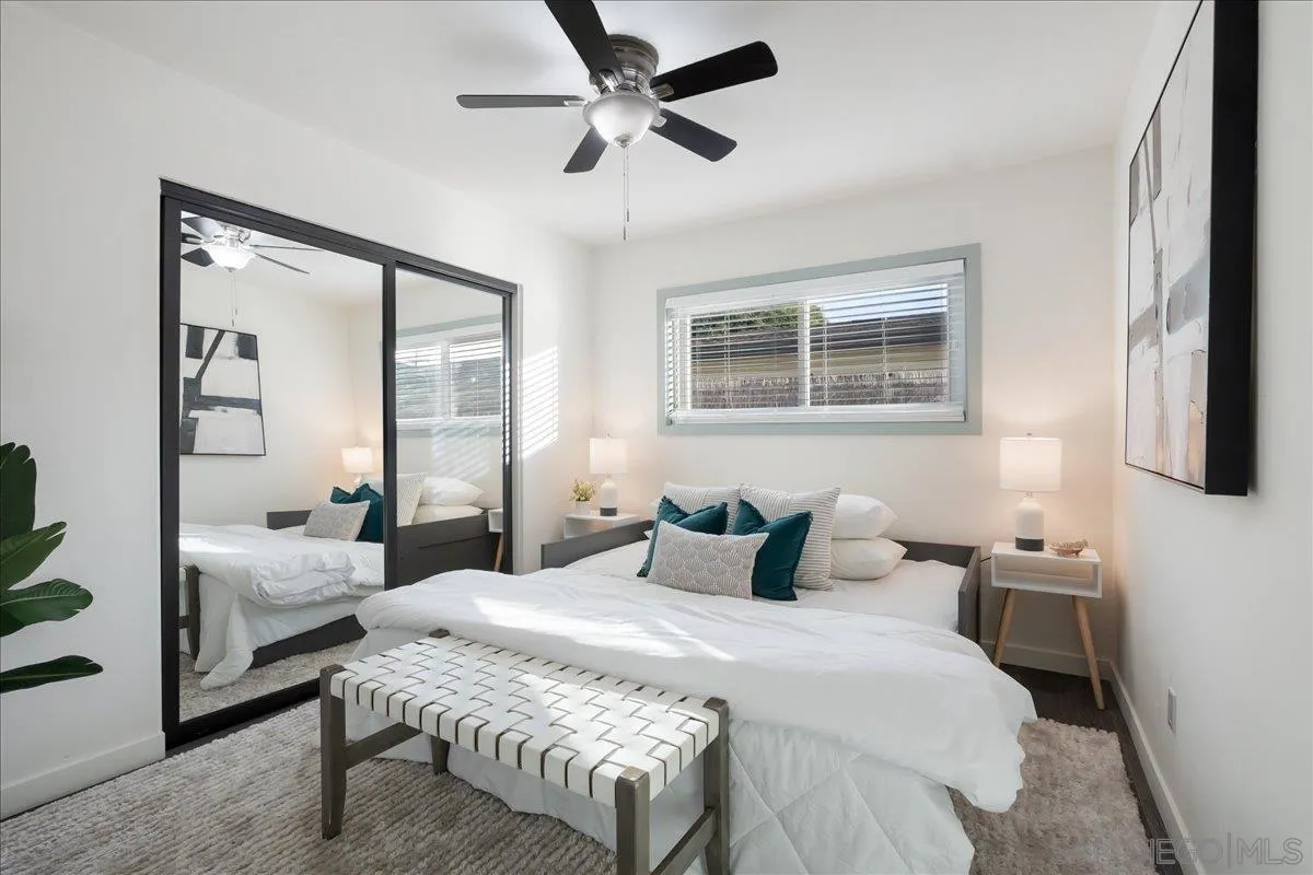 941 8th Street Imperial Beach, CA 91932 - Photo 13 of 22 a bedroom with a bed and a chandelier