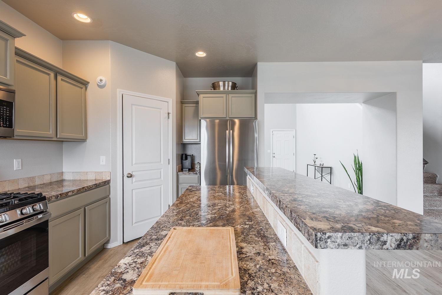 2515 Fallcrest Street Caldwell, ID 83607 - Photo 12 of 48 Kitchen with stainless steel appliances, gray cabinetry, light wood-type flooring, dark stone counters, and recessed lighting