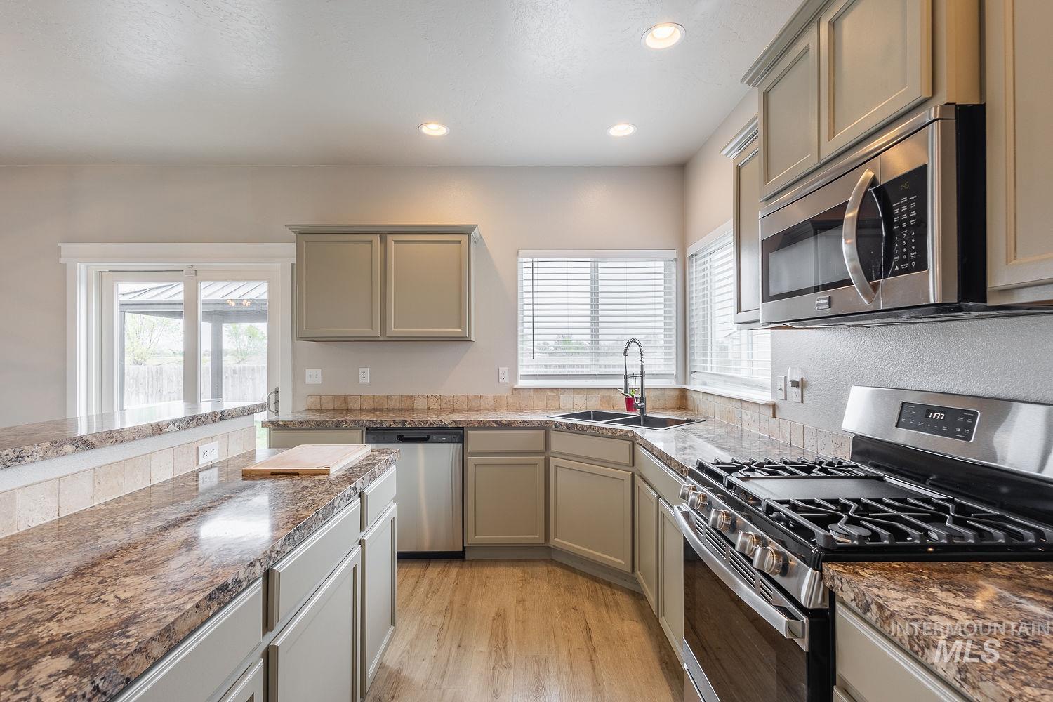2515 Fallcrest Street Caldwell, ID 83607 - Photo 14 of 48 Kitchen with stainless steel appliances, healthy amount of natural light, gray cabinets, and recessed lighting