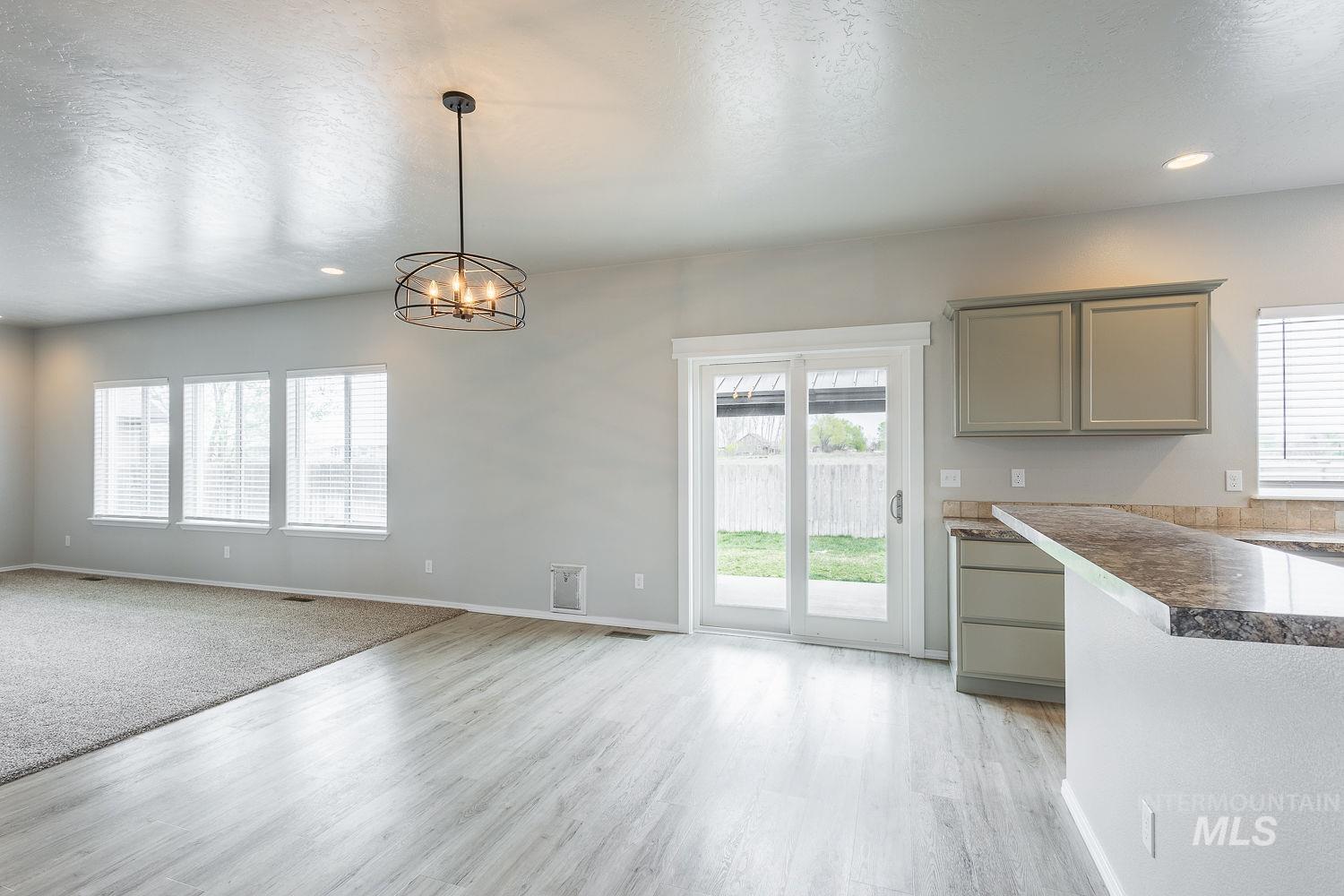 2515 Fallcrest Street Caldwell, ID 83607 - Photo 16 of 48 Unfurnished dining area featuring hanging lights, a textured ceiling, and light wood finished floors