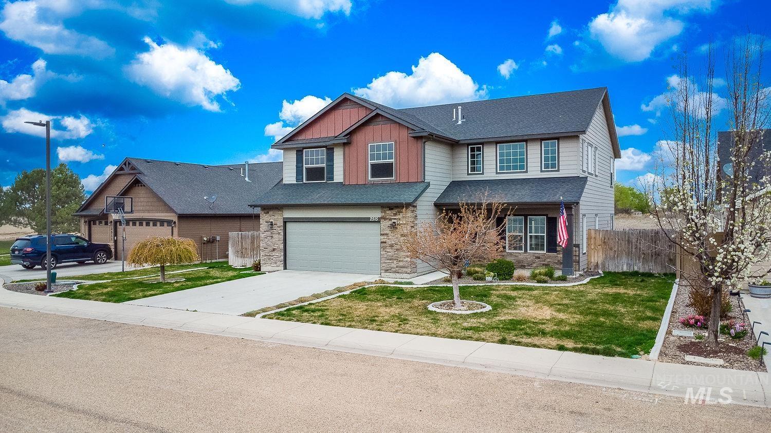 2515 Fallcrest Street Caldwell, ID 83607 - Photo 2 of 48 Craftsman house with board and batten siding, a porch, stone siding, driveway, and an attached garage