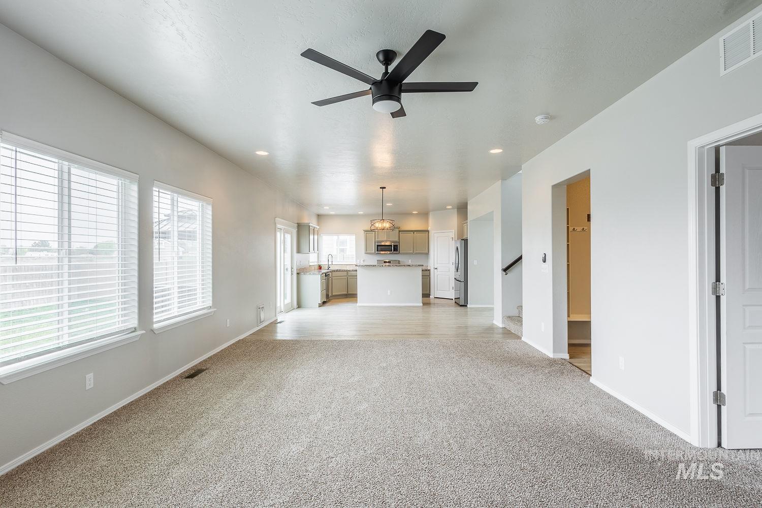2515 Fallcrest Street Caldwell, ID 83607 - Photo 20 of 48 Unfurnished living room featuring light carpet, ceiling fan, and recessed lighting