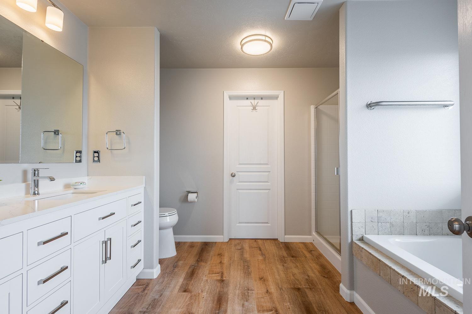 2515 Fallcrest Street Caldwell, ID 83607 - Photo 26 of 48 Full bathroom featuring vanity, a bath, a shower stall, and light wood finished floors