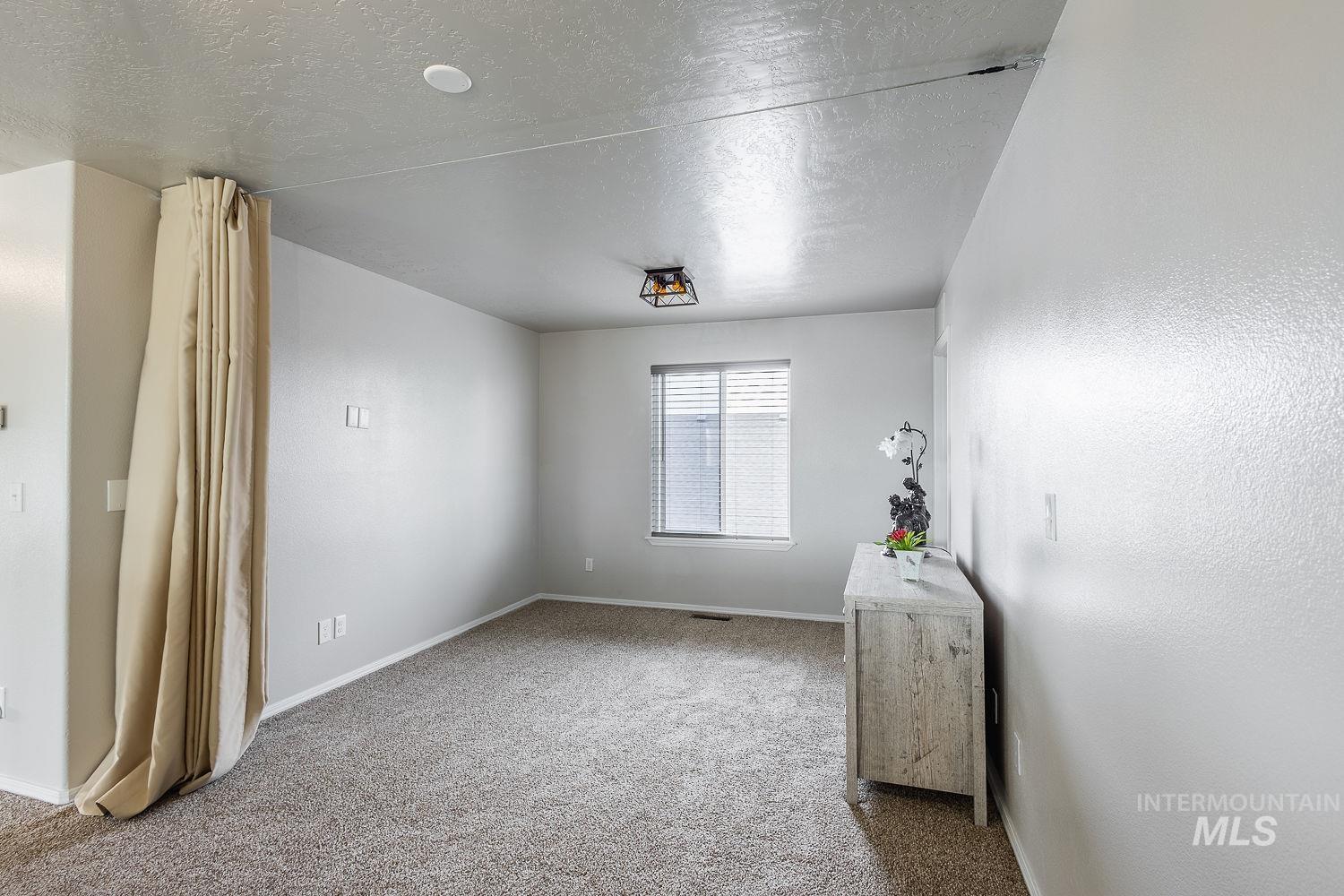 2515 Fallcrest Street Caldwell, ID 83607 - Photo 30 of 48 Spare room featuring a textured ceiling and light carpet