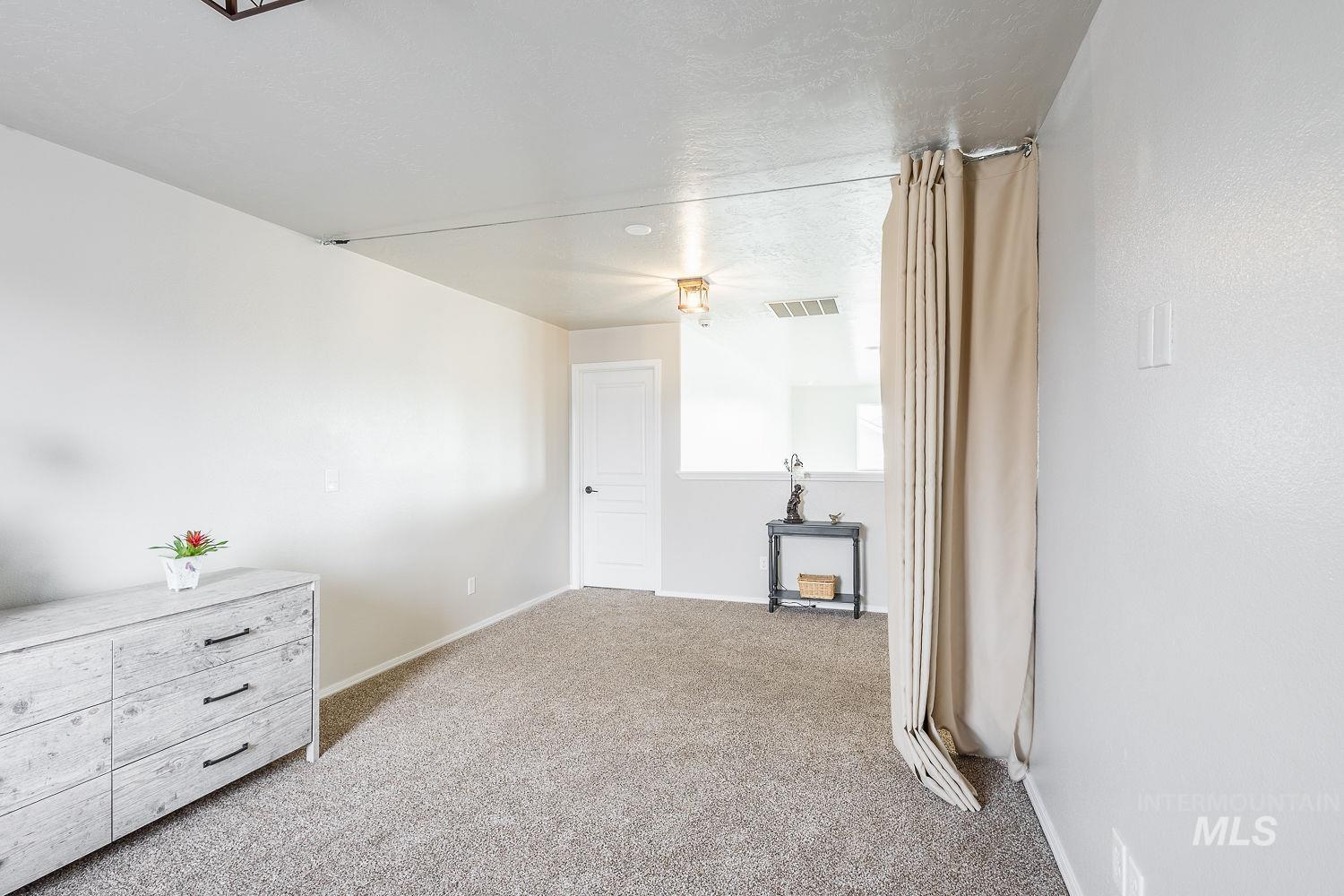 2515 Fallcrest Street Caldwell, ID 83607 - Photo 31 of 48 Spare room featuring light colored carpet and a textured ceiling