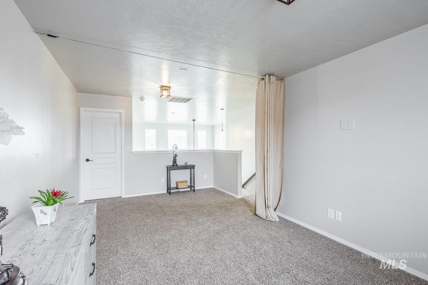 2515 Fallcrest Street Caldwell, ID 83607 - Photo 32 of 48 Unfurnished living room with carpet and a textured ceiling