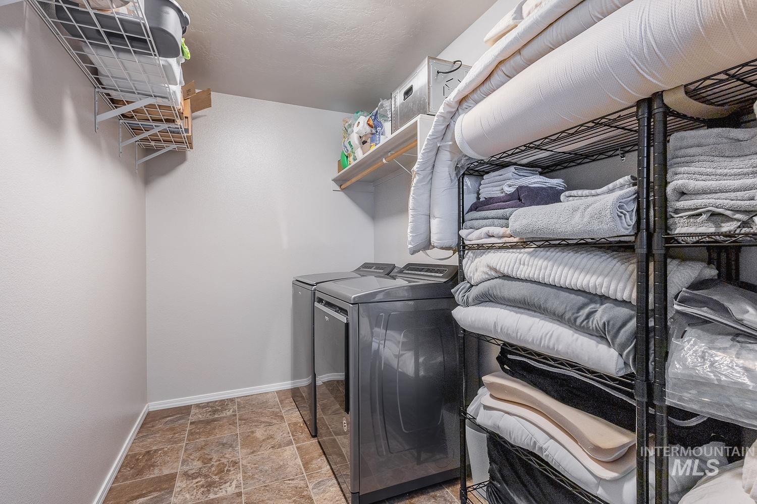2515 Fallcrest Street Caldwell, ID 83607 - Photo 38 of 48 Laundry room featuring stone finish flooring and washer and clothes dryer