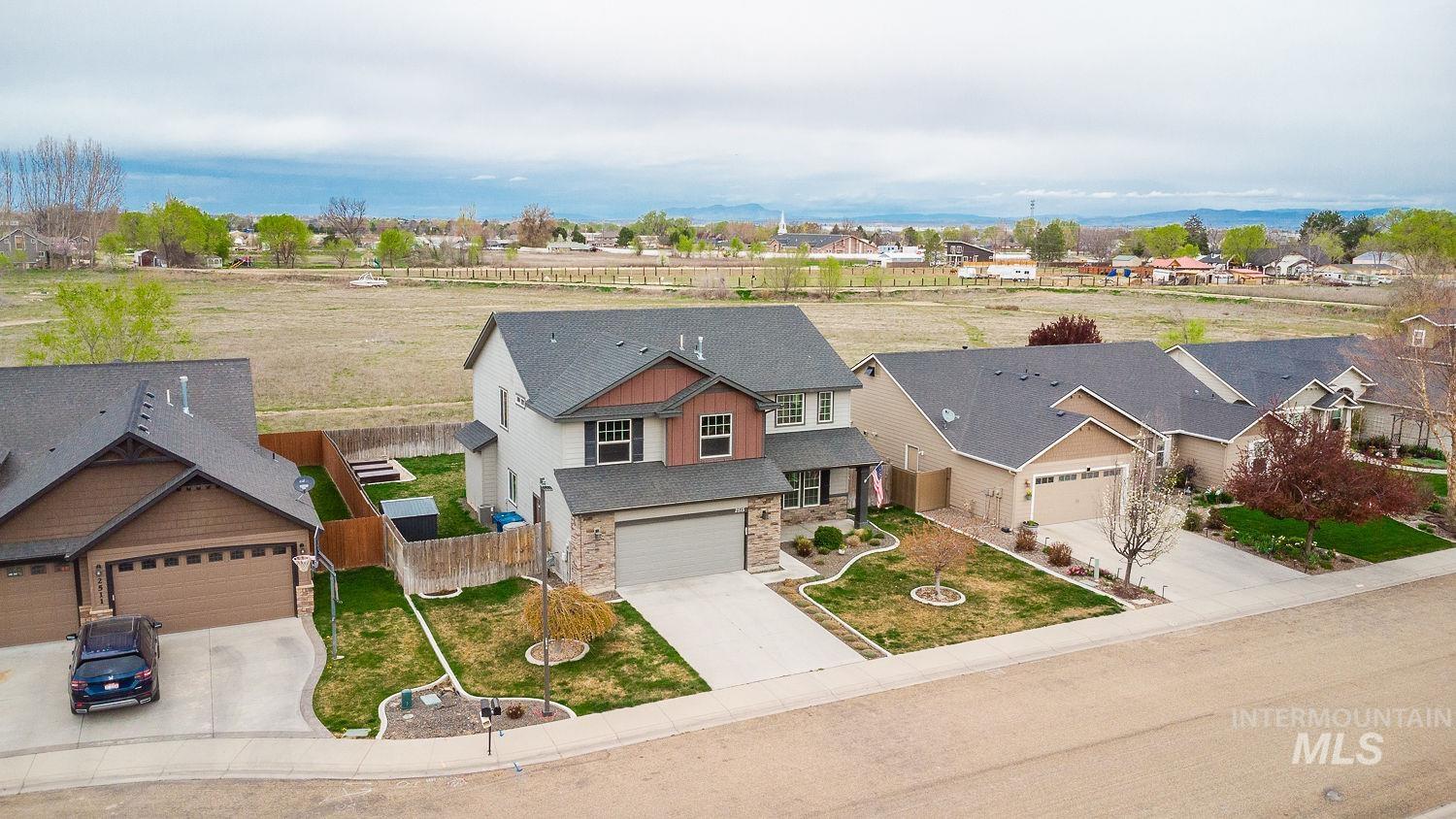 2515 Fallcrest Street Caldwell, ID 83607 - Photo 4 of 48 View of front of home featuring stone siding, driveway, and a residential view