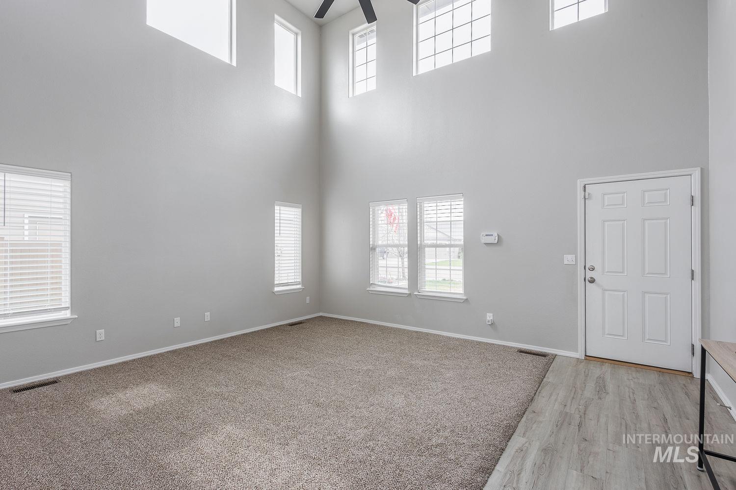 2515 Fallcrest Street Caldwell, ID 83607 - Photo 8 of 48 Spare room featuring plenty of natural light, a ceiling fan, a high ceiling, and light wood finished floors