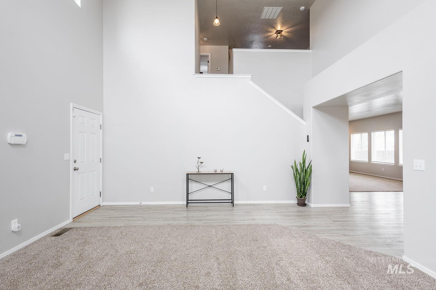 2515 Fallcrest Street Caldwell, ID 83607 - Photo 9 of 48 Unfurnished living room featuring a high ceiling and light colored carpet