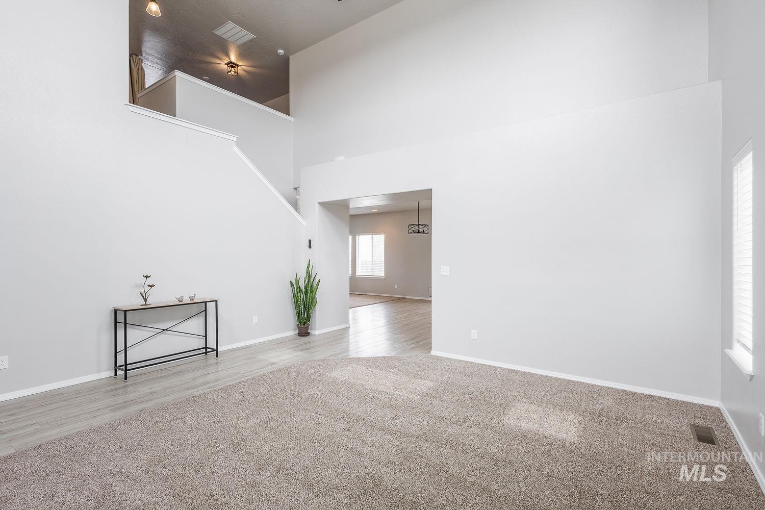 2515 Fallcrest Street Caldwell, ID 83607 - Photo 10 of 48 Unfurnished living room with a high ceiling and light carpet