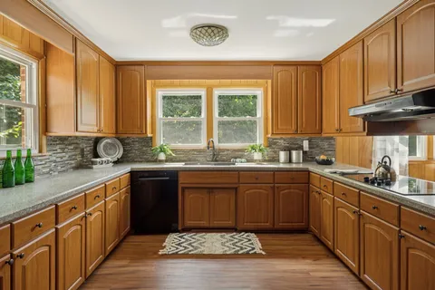 a kitchen with stainless steel appliances a refrigerator and a stove top oven