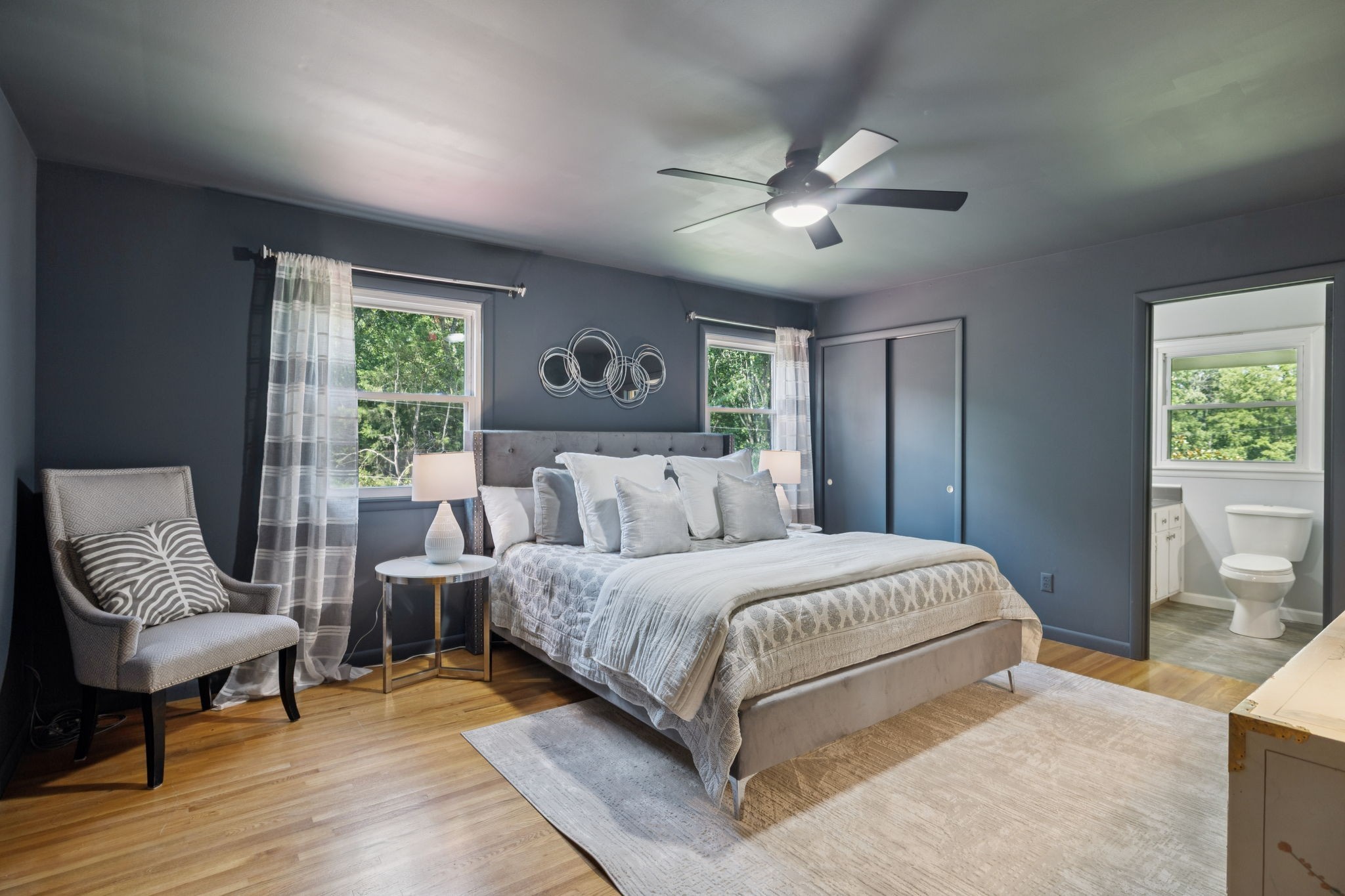 7199 Harper Road Joelton, TN 37080 - Photo 27 of 56 a bedroom with a large bed and a chandelier