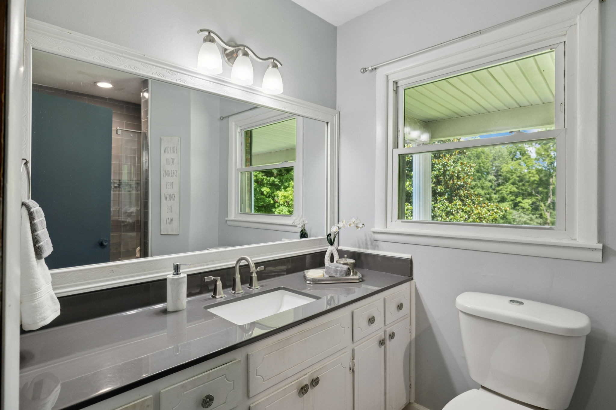 7199 Harper Road Joelton, TN 37080 - Photo 28 of 56 a spacious bathroom with a granite countertop sink a toilet and a window