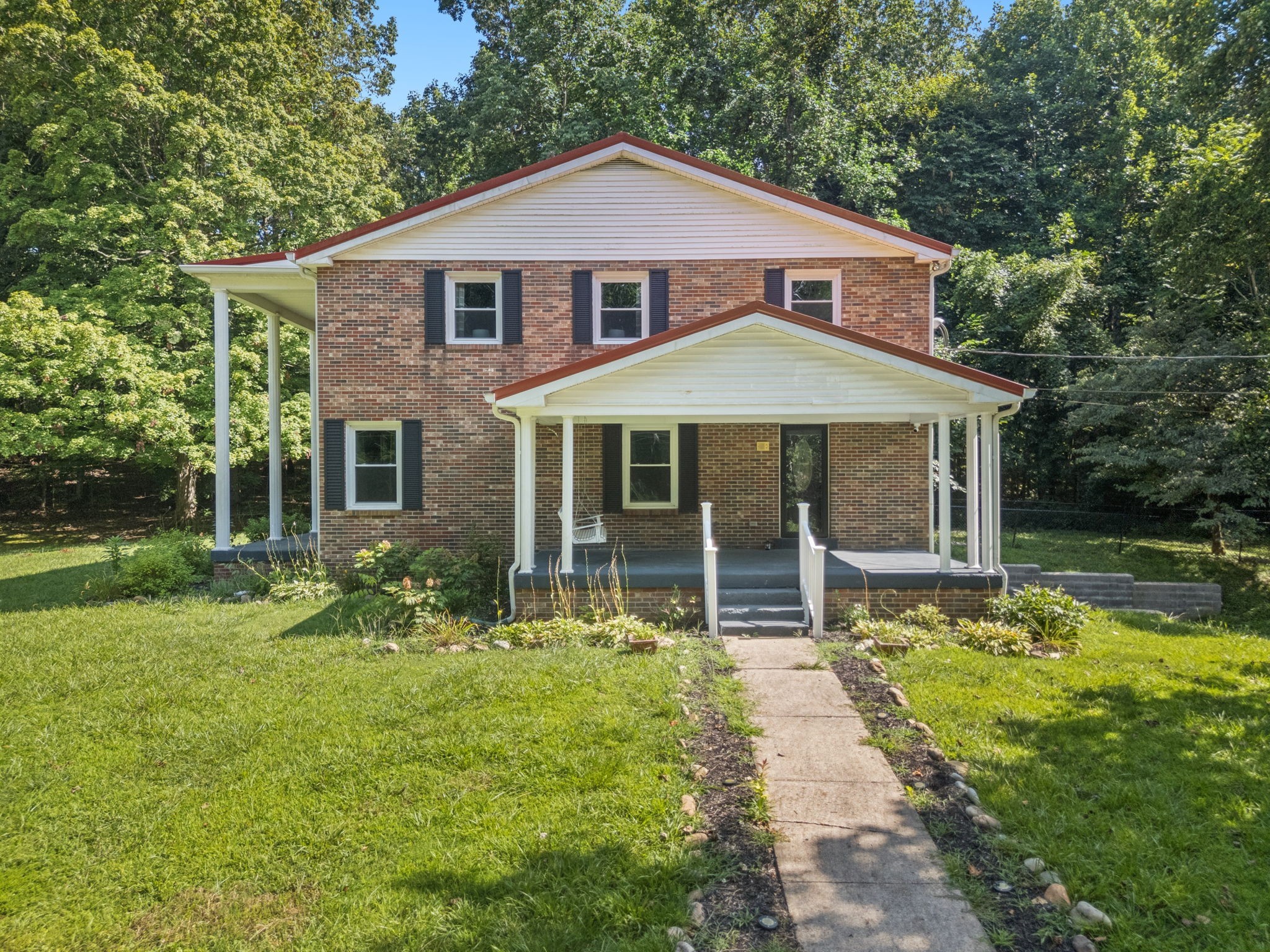 7199 Harper Road Joelton, TN 37080 - Photo 39 of 56 a front view of a house with garden