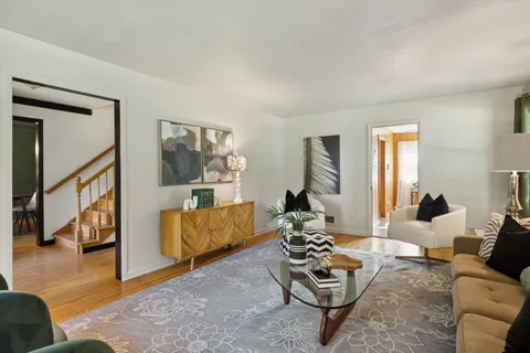 a view of a livingroom with furniture and a window