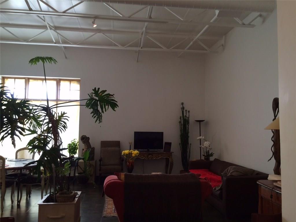 1371 Crampton Street, Unit 120 Dallas, TX 75207 - Photo 3 of 10 a living room with furniture and a flat screen tv